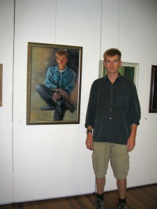 Jeff Meggs with his portrait at the Alice Bale exhibition.